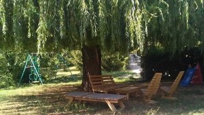A park with a wooden bench, a swing set, and a slide. - abundance, Stone house with land of 2000m2 at the foot of the vercors (La Baume-Cornillane)