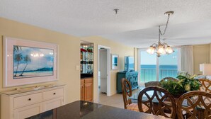A spacious kitchen with a dining area, a view of the ocean, and a balcony with a view of the sea. - Private Beach Access, Heated Pool, Beach Chairs + Free Attraction Tickets! (Santa Rosa Beach)