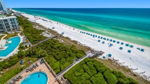 A resort with a large pool, a beach with umbrellas, and a clear view of the ocean. - Gulf-Front w/ Private Beach Access + Free Beach Setup & Attraction Tickets! (Santa Rosa Beach)