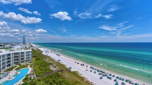 A beach resort with a pool area, beach umbrellas, and a clear view of the ocean. - Modern Gulf Front Condo, Private Beach Access, Beach Service + Free Tickets! (Santa Rosa Beach)