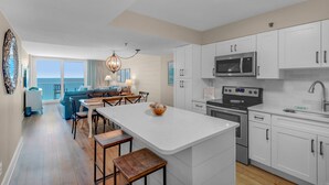 A modern kitchen with white cabinets, a stainless steel microwave, and a built-in oven. - Gulf Front w/ Private Beach, Free Seasonal Beach Chairs & Attraction Tickets! (Santa Rosa Beach)