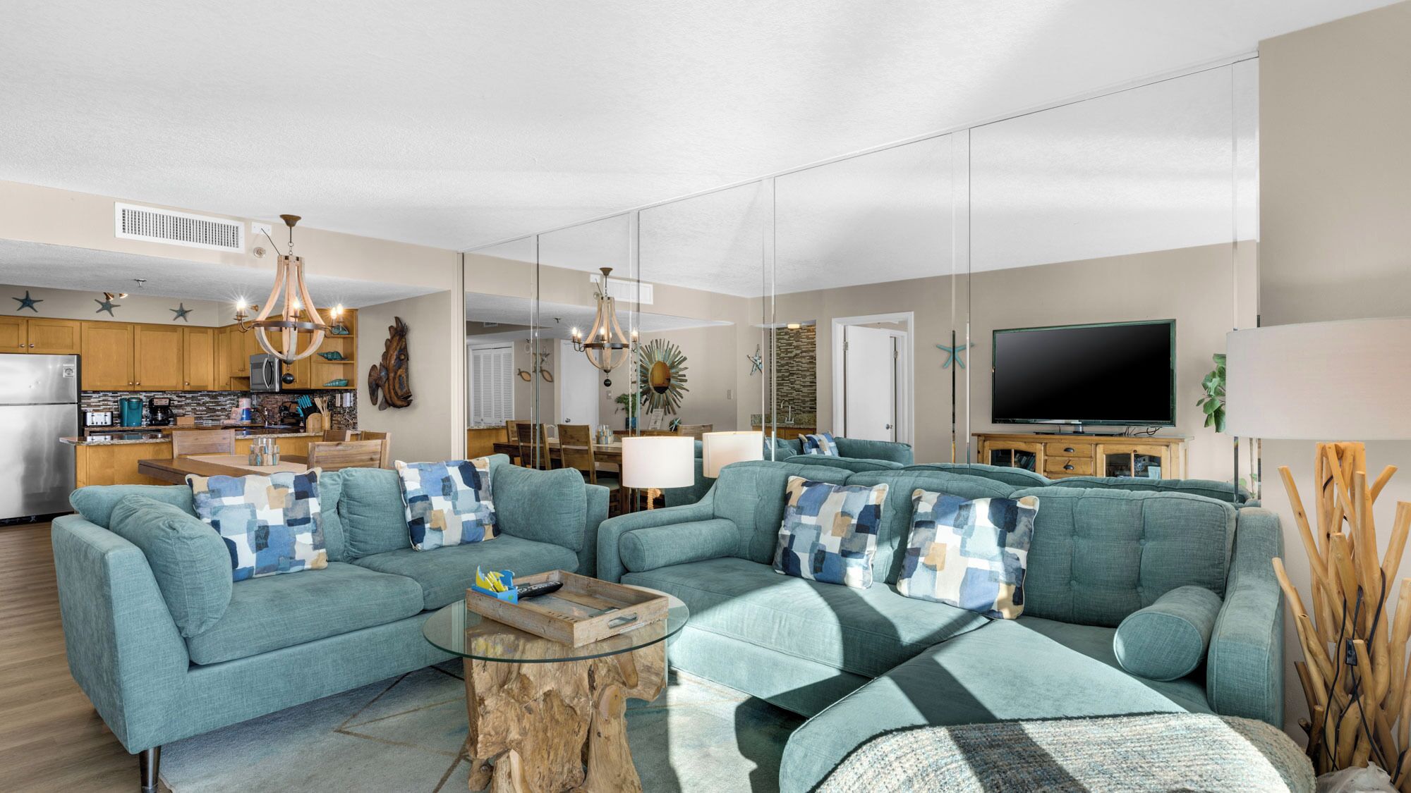 A modern living room with a sofa set, a coffee table, and a TV.