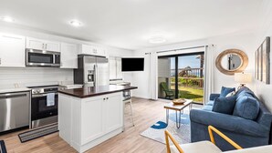 A modern kitchen with white cabinets, stainless steel appliances, and a central island. - 1st Floor, Gulf Side in Seagrove,  Sleeps 6 + Free Attraction Tickets! (Santa Rosa Beach)