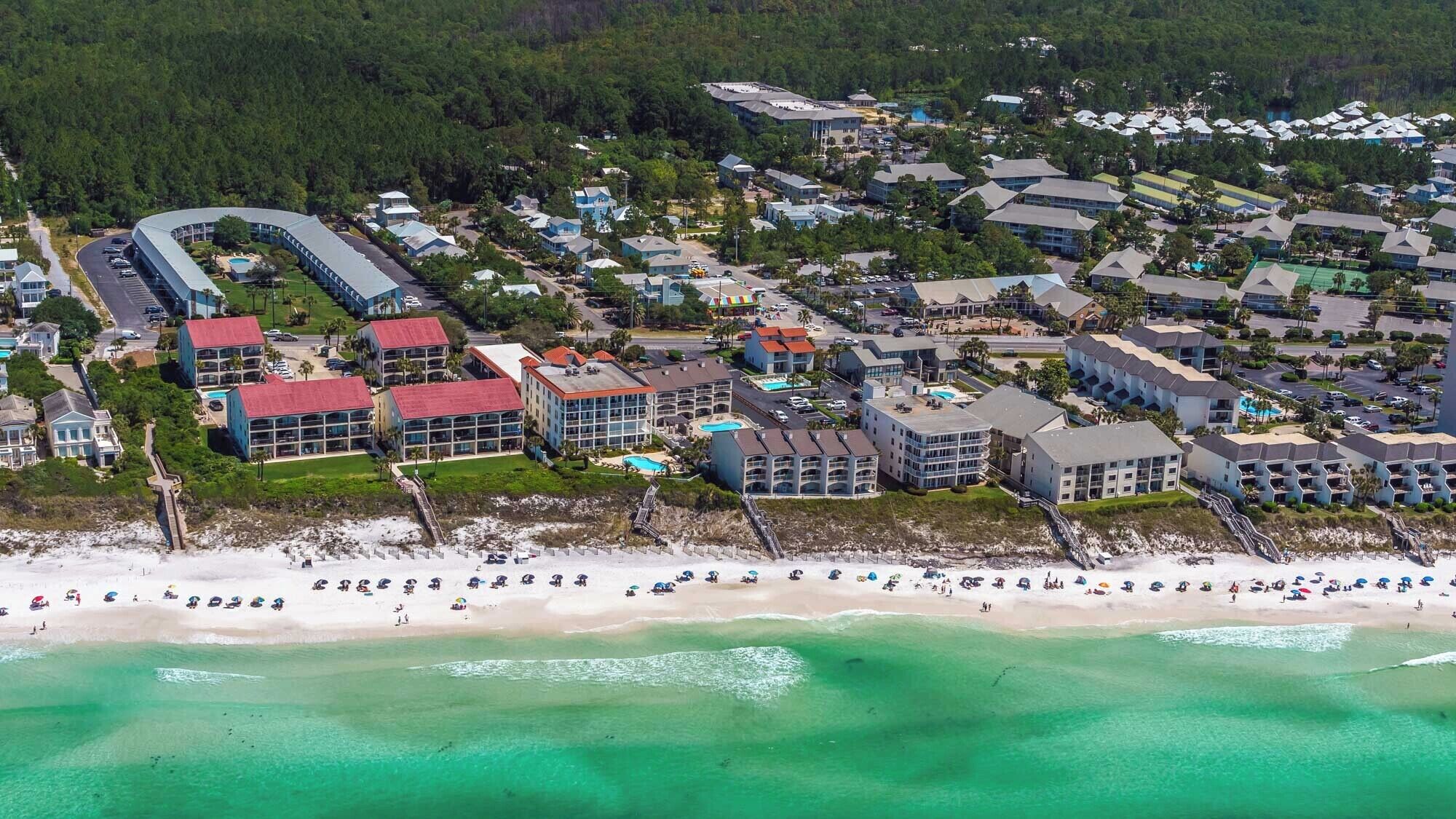 A coastal resort with beachfront properties, a marina, and a variety of building styles.