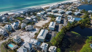 An aerial view of a coastal hotel area with multiple buildings, a beach, and a body of water. - Ground Floor, 2 Pools, Tennis, Beautiful Community + Free Attraction Tickets! (Santa Rosa Beach)