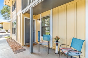 Guests can enjoy a quiet moment on the porch with a small table and two chairs.