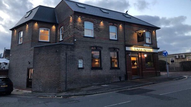 A two-story brick building with a sign reading "EAGLE HOTEL". - Eagle Hotel (Luton)