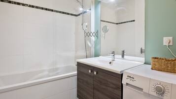 Bathtub, hair dryer, towels, soap