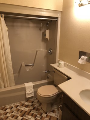 A bathroom with a bathtub, toilet, and sink. - Latham Inn (Latham)