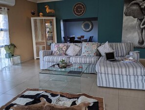 Sunbirds Chobe Villa | Living area | 65-inch Smart TV with cable channels, TV