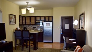 A compact living space with a kitchenette, dining area, and a small seating area. - Free Breakfast + Outdoor Pool + 24 Hour Fitness Center (Stafford)