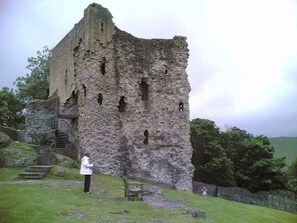 A historic stone castle with a staircase leading to the upper levels.