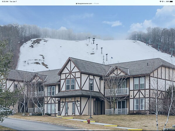 Traditional chalet-style building with exposed beams and steeply pitched roof.