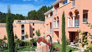 A multi-story hotel with a consistent architectural style, featuring balconies and arched windows.