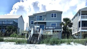 A beachfront property with a staircase leading to a multi-level building, surrounded by sand and vegetation. - Paradise Sands 5bed/3 bath+home office Sleeps 13  (Murrells Inlet)