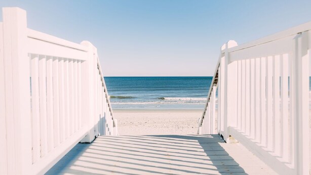 A wooden boardwalk leading to a beach with a clear view of the ocean. - Paradise Sands 5bed/3 bath+home office Sleeps 13  (Murrells Inlet)