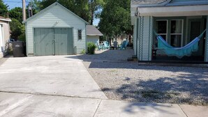 A residential property with a garage, a covered porch, and a hammock.