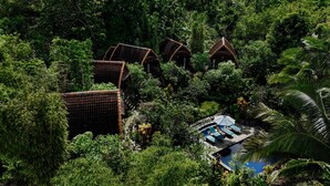 A resort with multiple bungalow-style buildings surrounded by dense tropical vegetation. - The Tukad Gepuh Cottage (Penida Island)