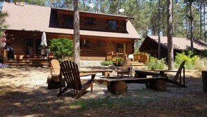 A rustic cabin with a porch, outdoor seating, and a fire pit. - 🏞Secluded Log Cabin Near Wisconsin Dells & Wisconsin River • Fireplace • Ski 🏕 (Lyndon Station)