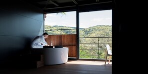 A modern room with a large window, a wooden floor, and a white chair. - THE Retreat (Iizuka)