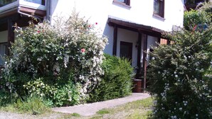 A building with a gravel pathway leading to a wooden door.