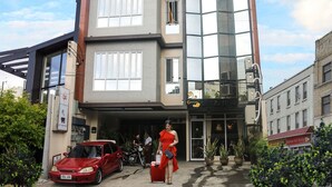 A modern building with a sign reading "DAVAO PERSIMMON SUITES". - Davao Persimmon Suites (Davao)