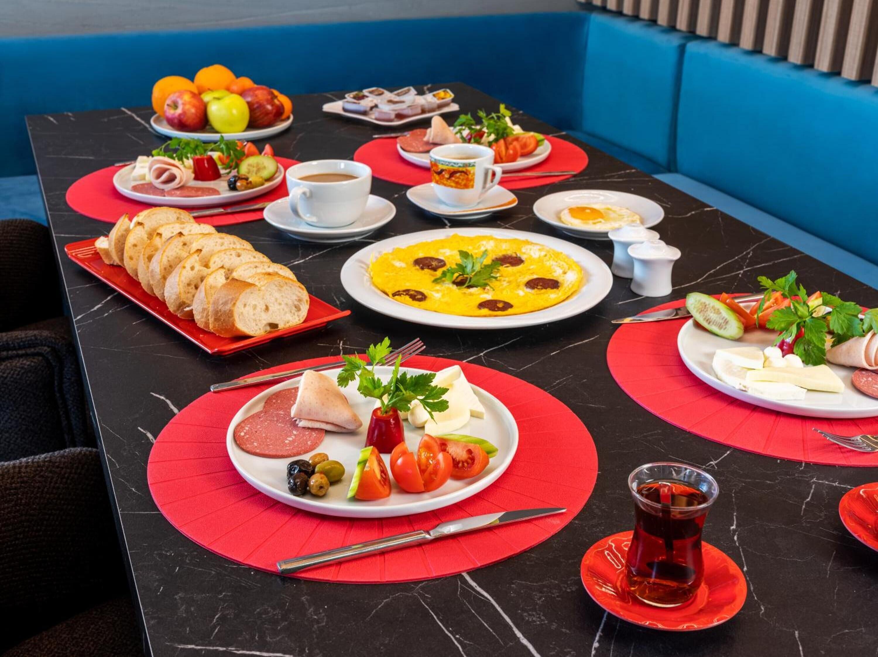 A breakfast buffet with various food items and beverages.