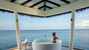 A large hot tub on a wooden deck with a view of the ocean. - Radisson Blu Resort Maldives with 50 percent off on Sea Plane round trip 03 nights & above (Huruelhi Island)