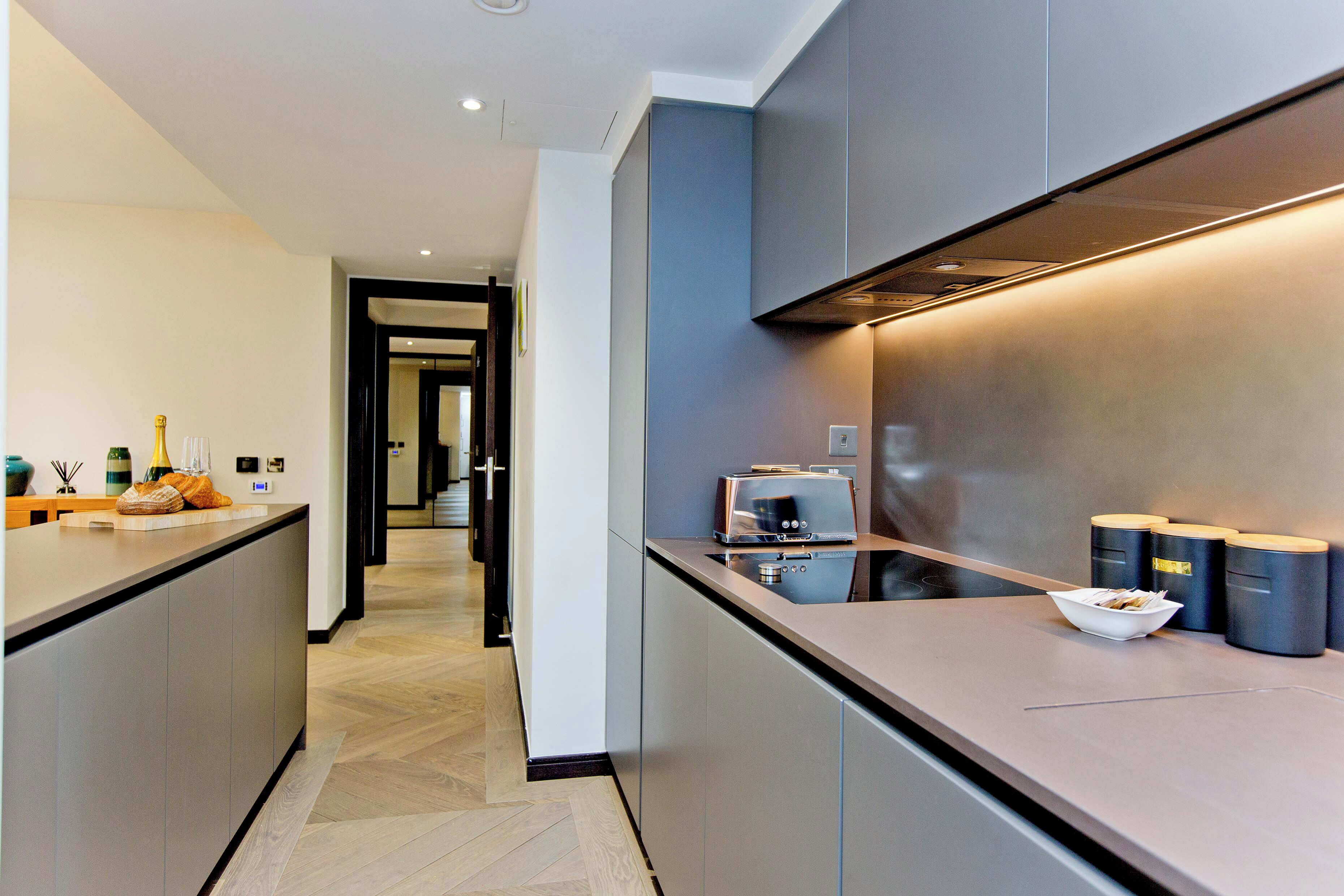 A modern kitchen with a central island, built-in appliances, and a sleek design.