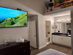 King size bed in master bedroom with 55" smart tv