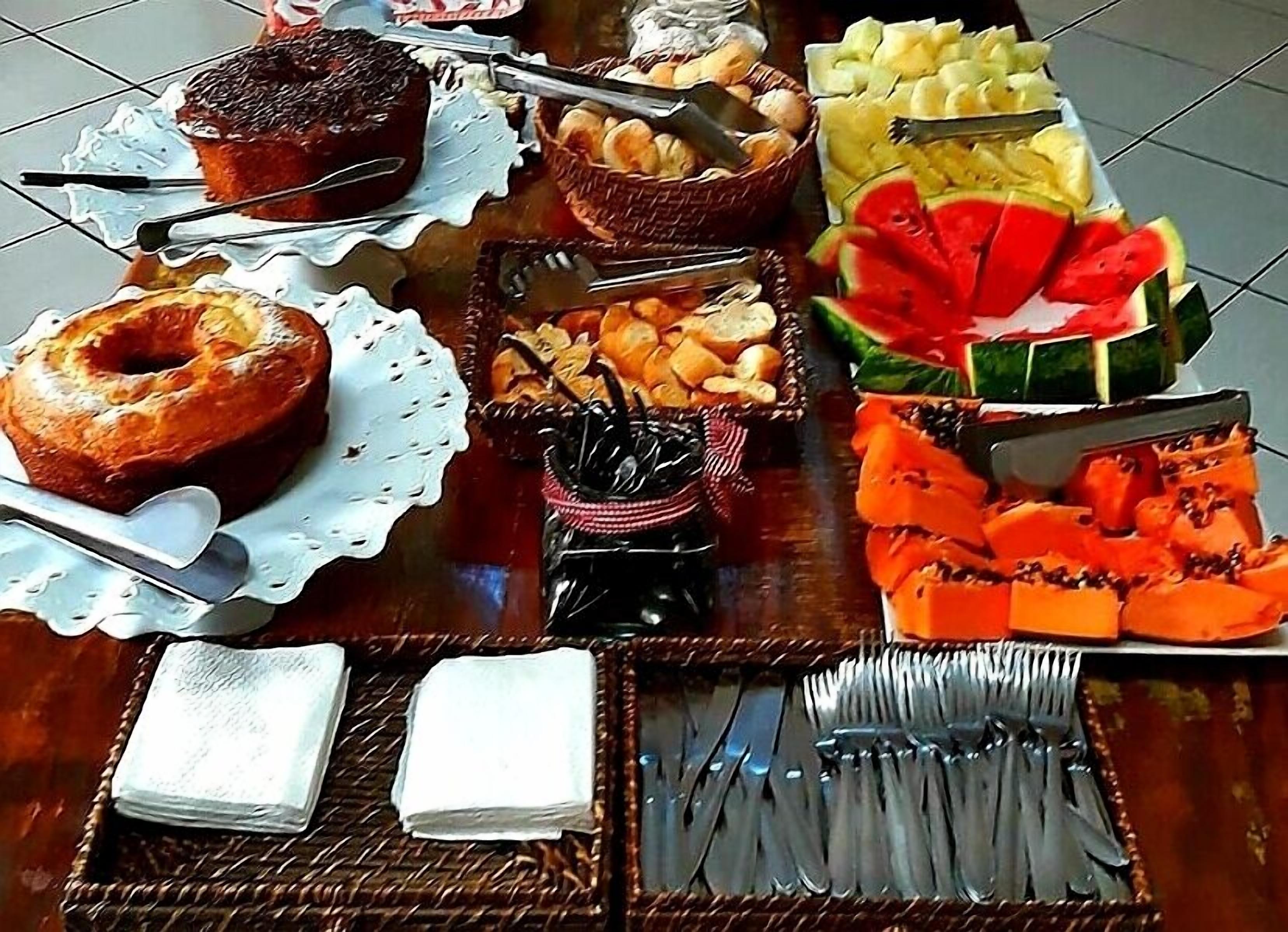 A breakfast buffet with various food items and utensils.