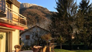 A building with a balcony overlooking a mountainous area.