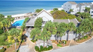 A coastal residential area with a swimming pool, multiple-story buildings, and a view of the ocean. - Barrier Dunes Cottage  Steps from beach/pool/tennis. 2/2 plus loft - SPECIALS!!! (Port St Joe)