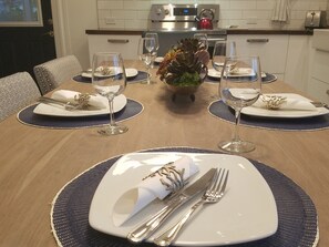 Enjoy a meal in this inviting dining area, complete with a beautifully set table and comfortable seating.