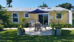 Enjoy al fresco dining on the patio with a dining table, chairs, and outdoor grill.