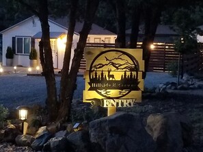 A sign for Hillridge Ranch with a deer and trees logo, indicating entry to the property.