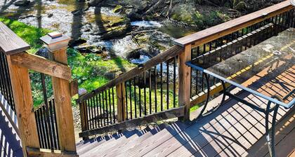Beautiful 2 BR cabin with a wall of windows overlooking the deck and stream.