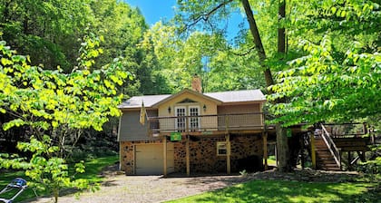 Beautiful 2 BR cabin with a wall of windows overlooking the deck and stream.