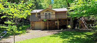Beautiful 2 BR cabin with a wall of windows overlooking the deck and stream.