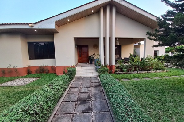 The front lawn is a colourful oasis that greets you with lush greenery.