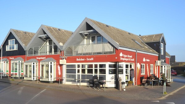 Experience the charm of this traditional building, home to a pizza restaurant, café, and shop, with outdoor seating and a small garden.
