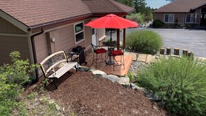 A house with a patio, a red umbrella, a bench, and a grill. - New Montana Modern Cottage overlooking Flathead Lake (Somers)