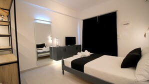 A modern bedroom with a bed, a dresser, a mirror, and a television. - Jericho rooms (Sarandë)