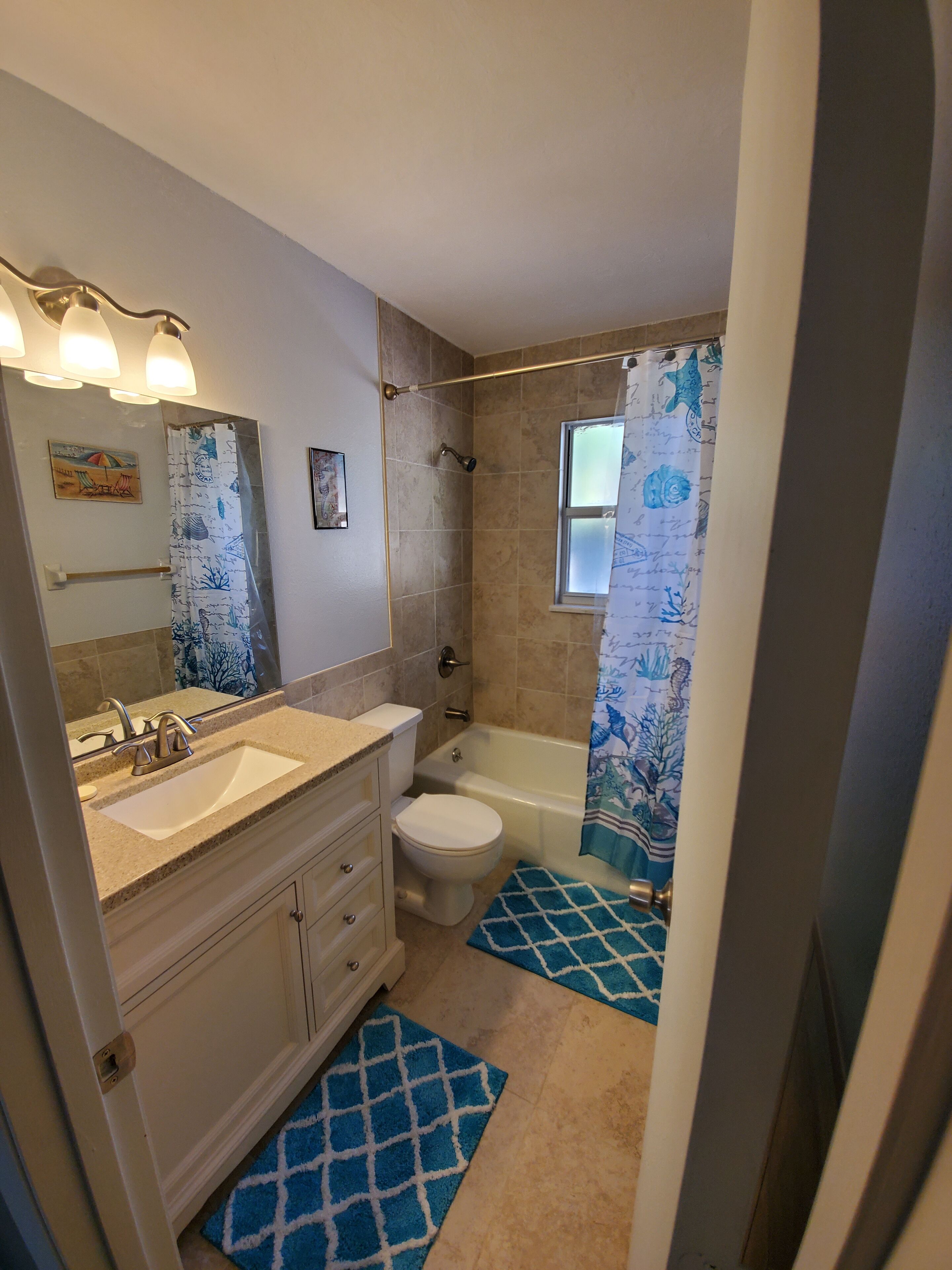 A bathroom with a sink, toilet, and bathtub.