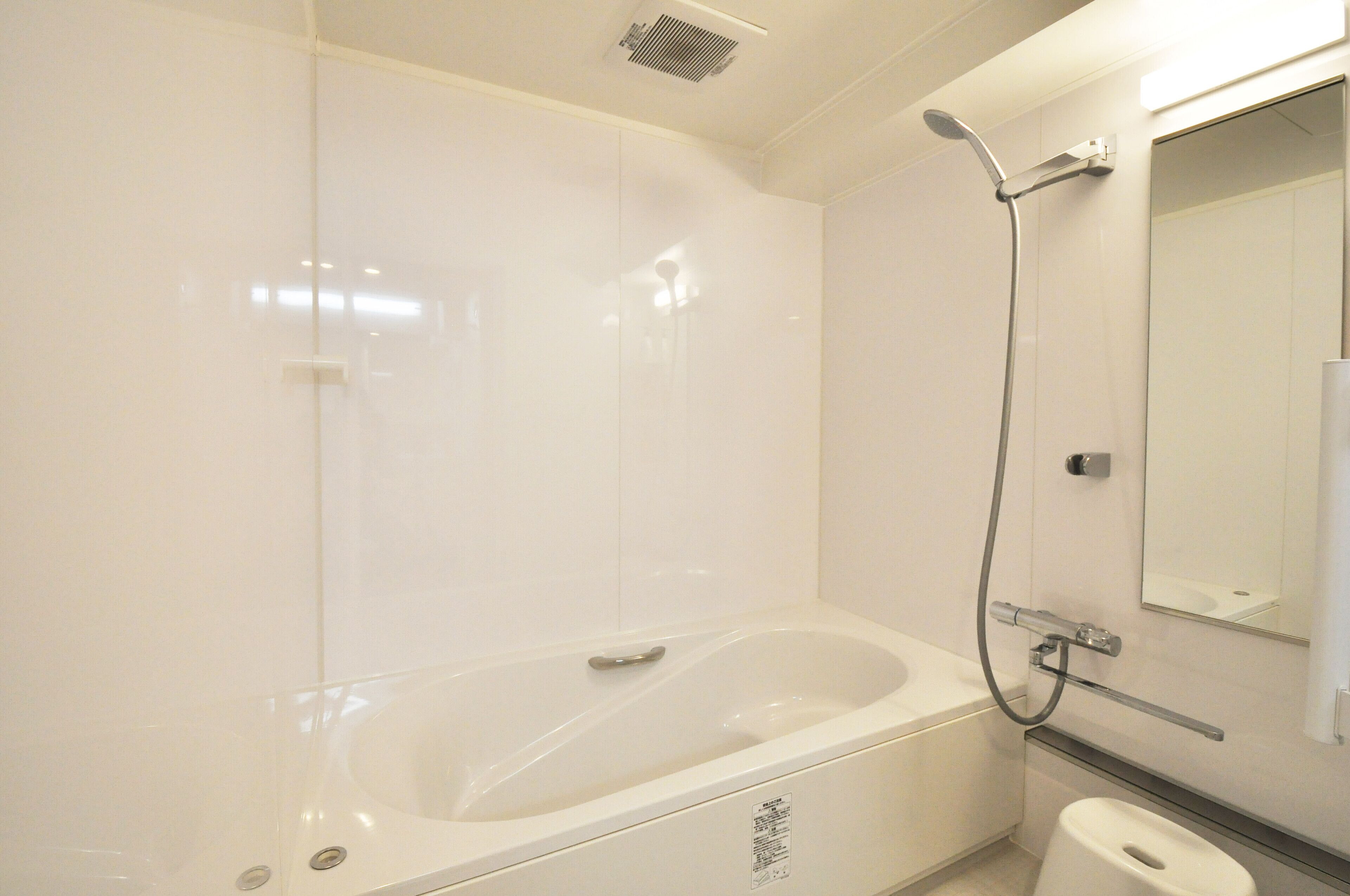 A bathroom with a bathtub, a toilet, and a shower.