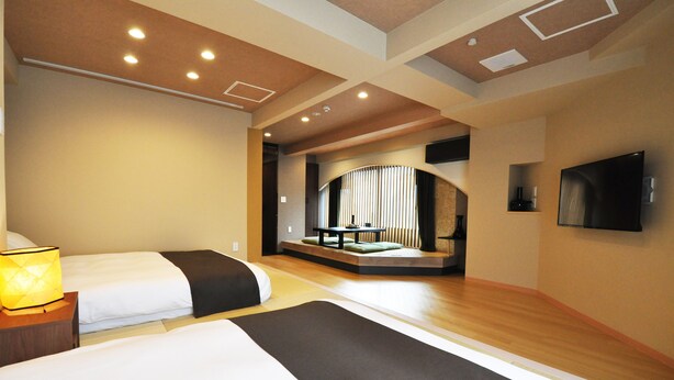 A hotel room with two beds, a seating area with a view, and a flat-screen TV mounted on the wall. - Senlax Inn Osaka (Osaka)