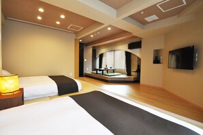 A hotel room with two beds, a seating area with a view, and a flat-screen TV mounted on the wall. - Senlax Inn Osaka (Osaka)