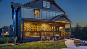A two-story house with a stone facade, wooden porch, and a small garden. - THEATER/GAME ROOM w/100” Screen!! Pool Table!  Dining Seats 20! 3 Living Areas! (Hollister)