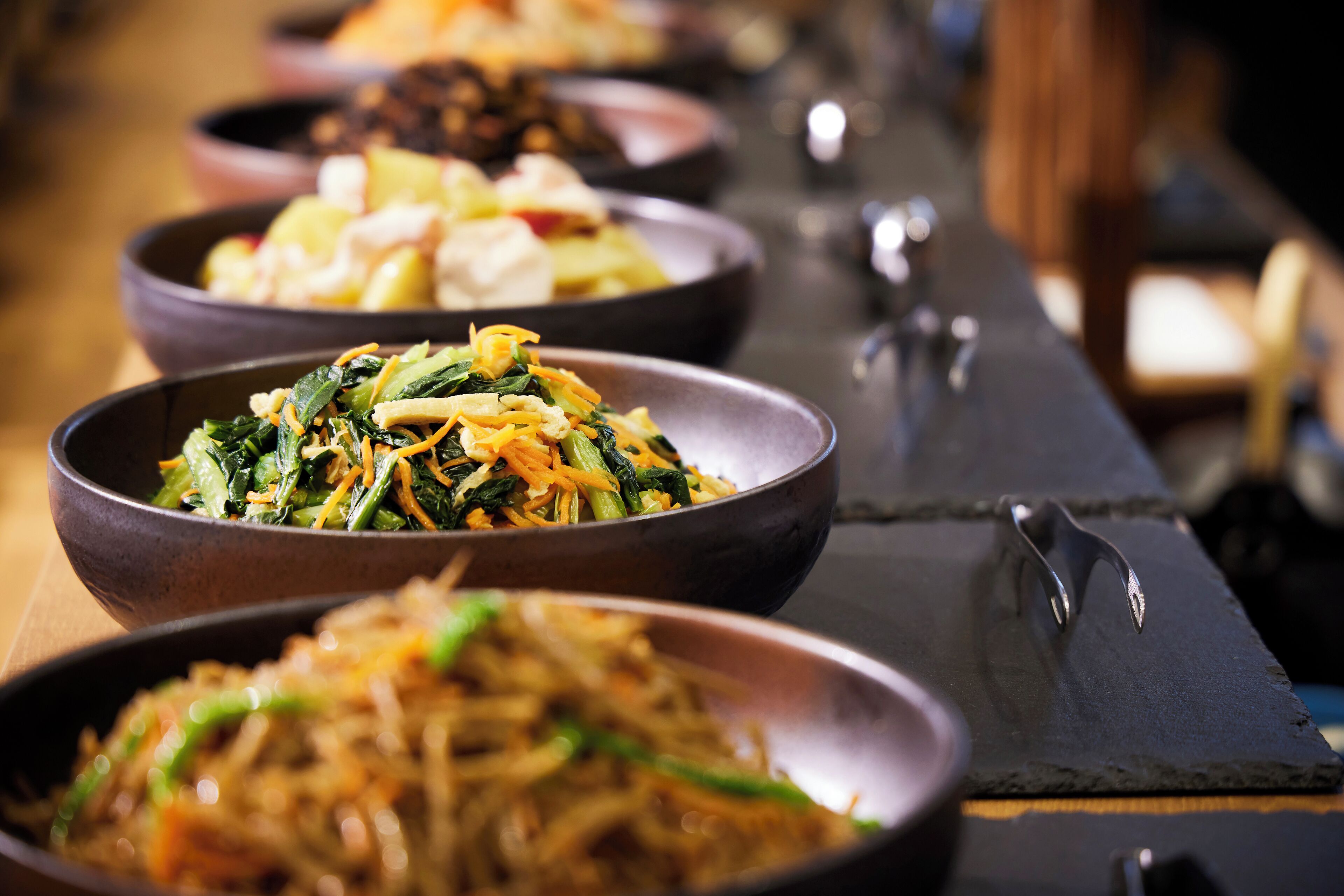 A variety of dishes in bowls on a table.