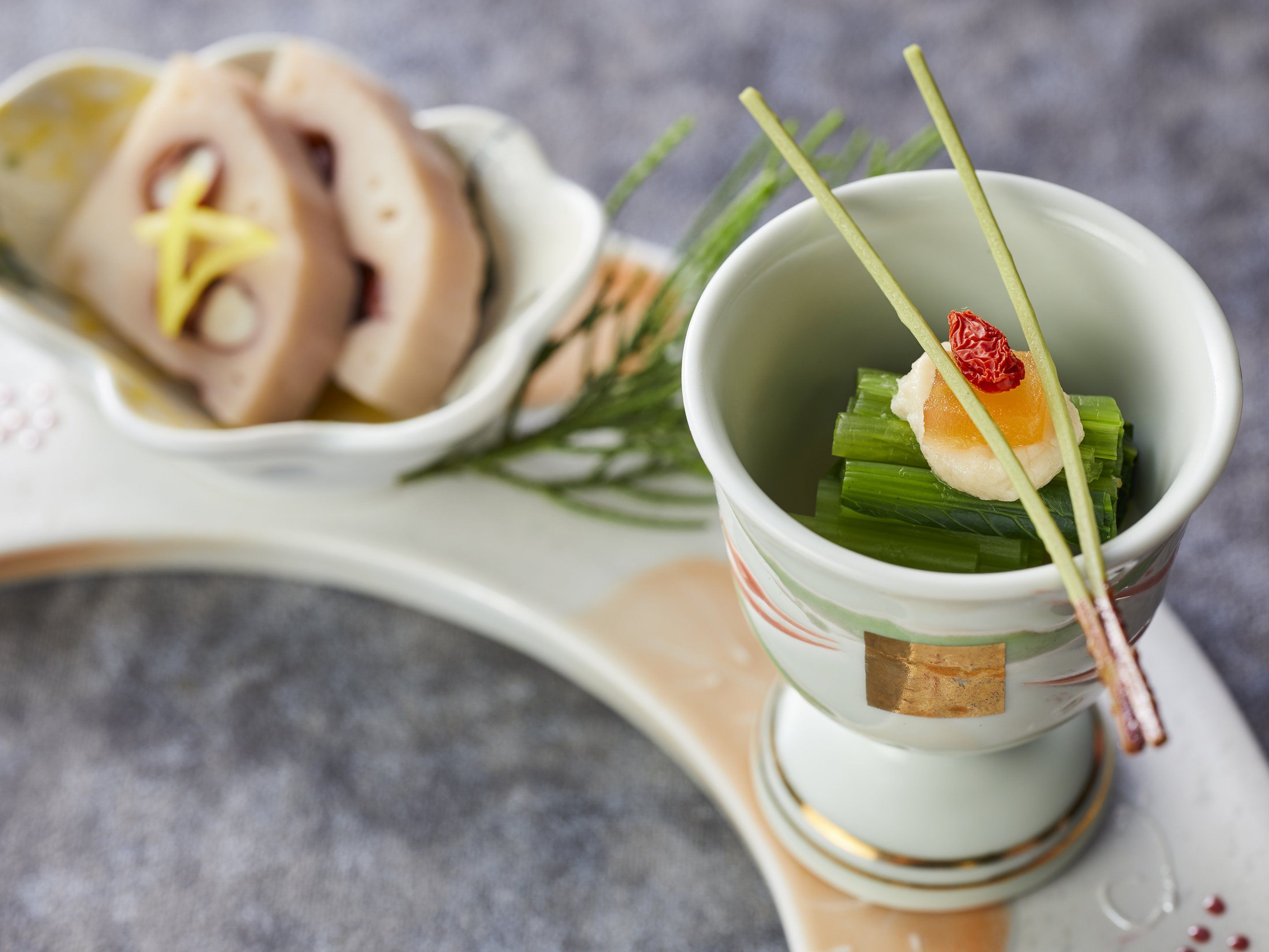 A traditional Japanese dish with a small bowl on a tray.